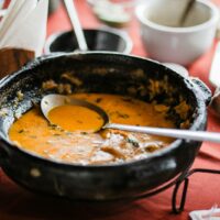 a bowl of soup with a spoon in it
