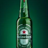 heineken beer bottle on green surface