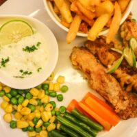 fried chicken and fries on white ceramic plate